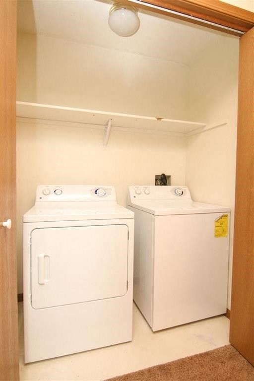 a washer and dryer in a room with a closet