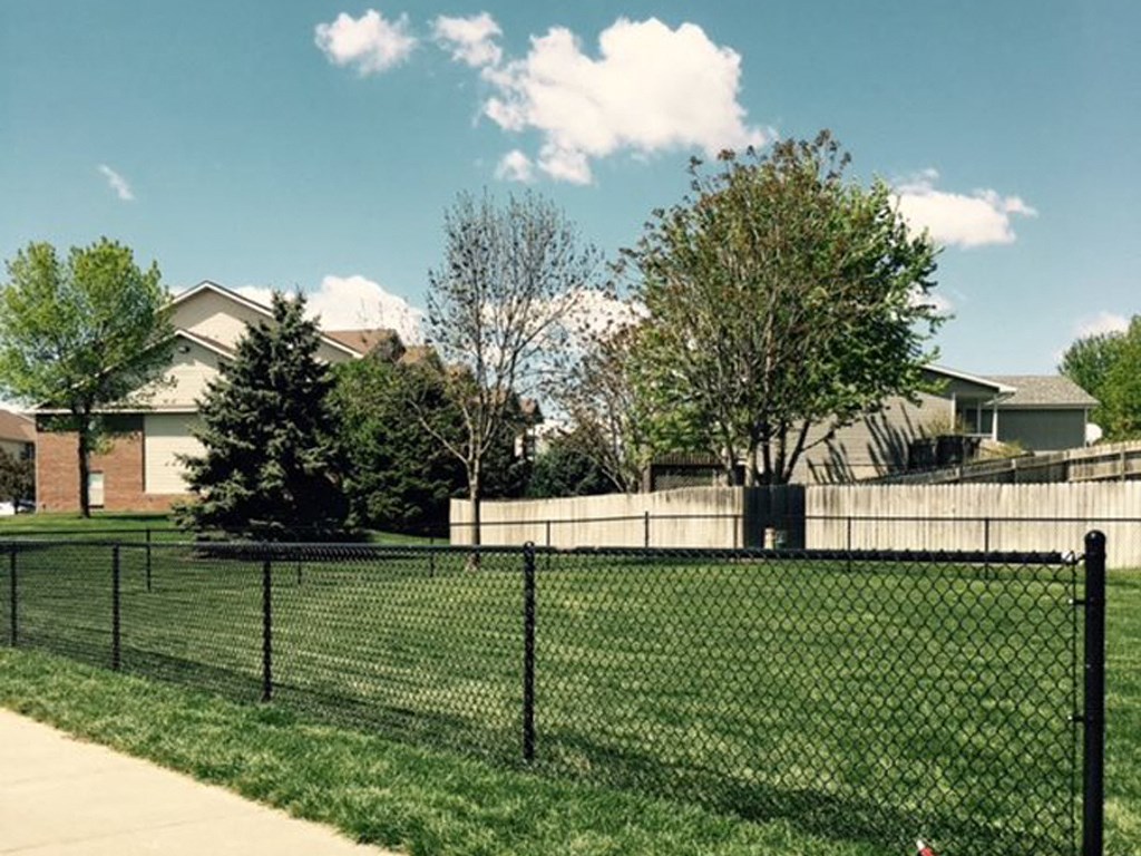a chain link fence in front of a house