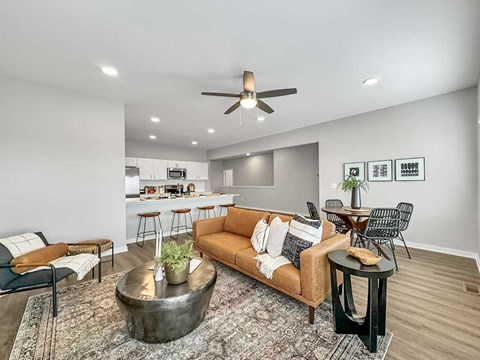 A living room with a brown couch and a coffee table.