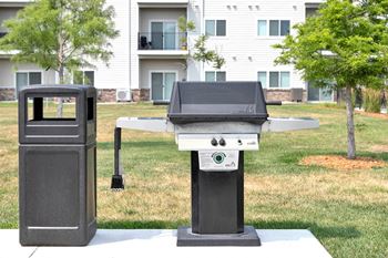 A black grill is in front of a white building.