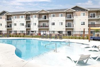 A swimming pool in front of apartment buildings.