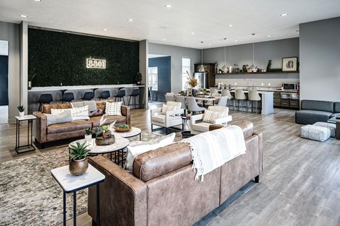 A modern living room with a large couch and a dining area in the background.