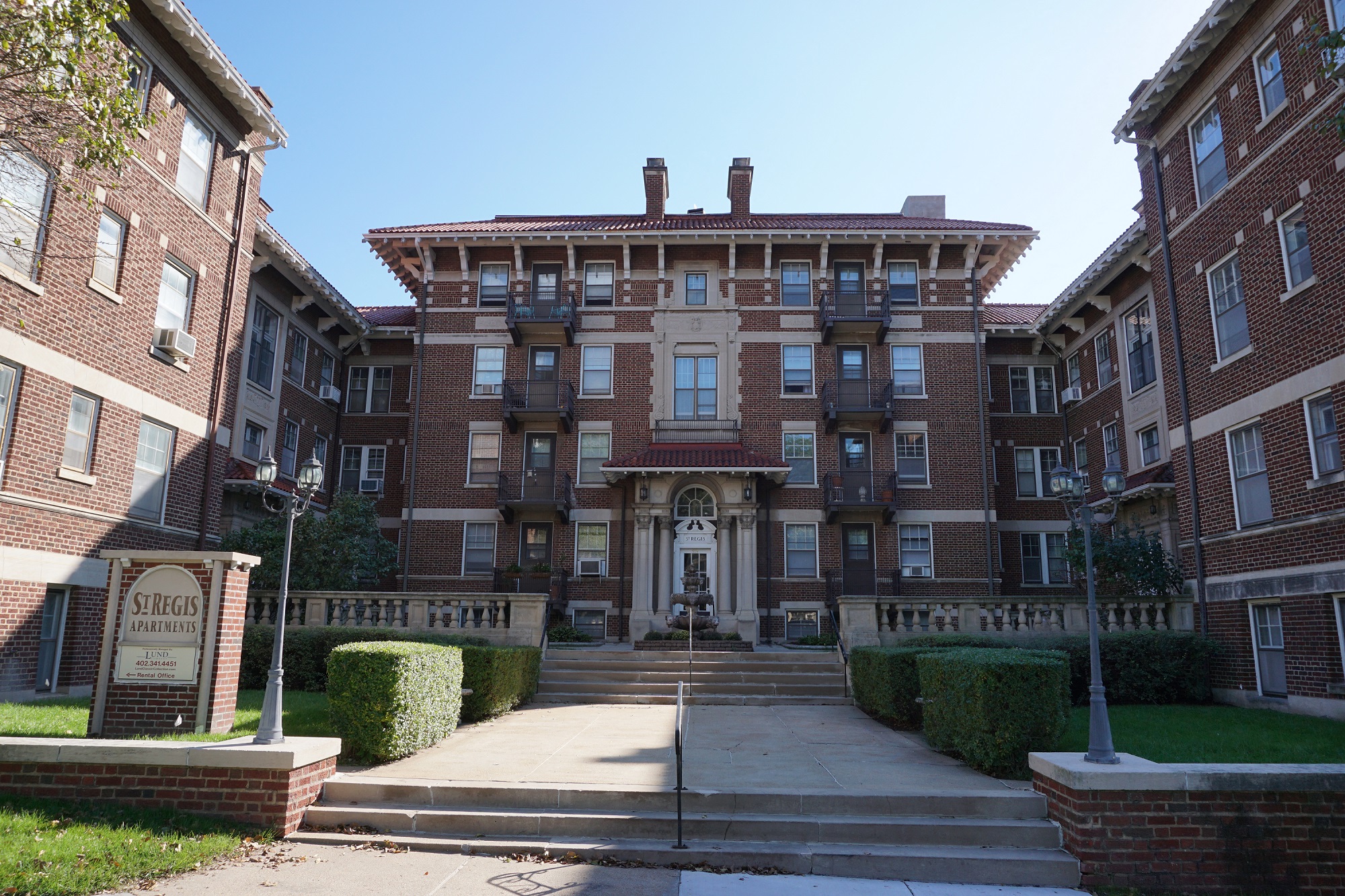 a large brick building with stairs in front of it