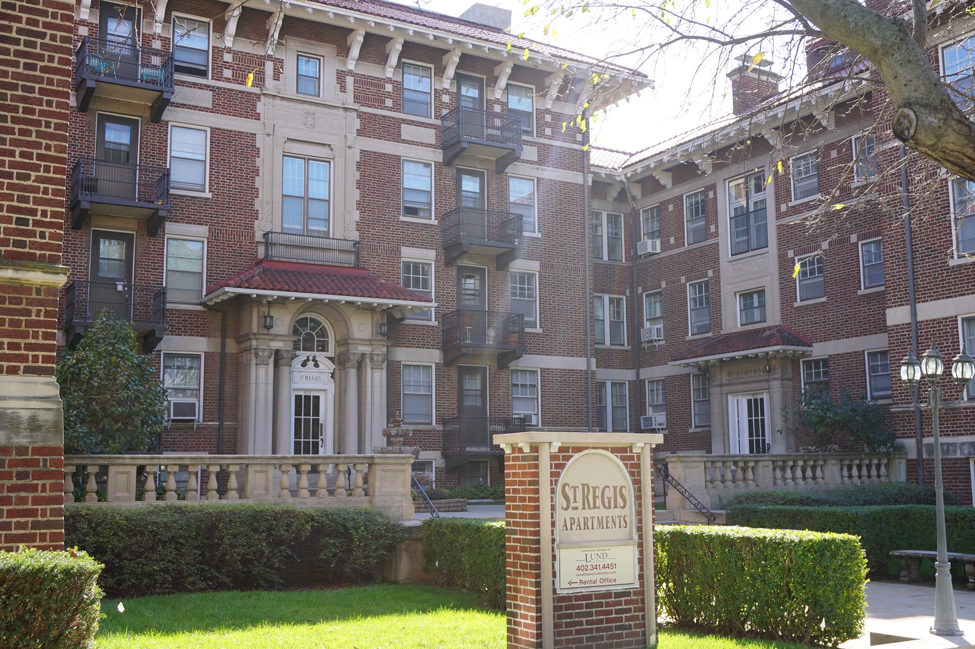 a large brick building with a sign in front of it