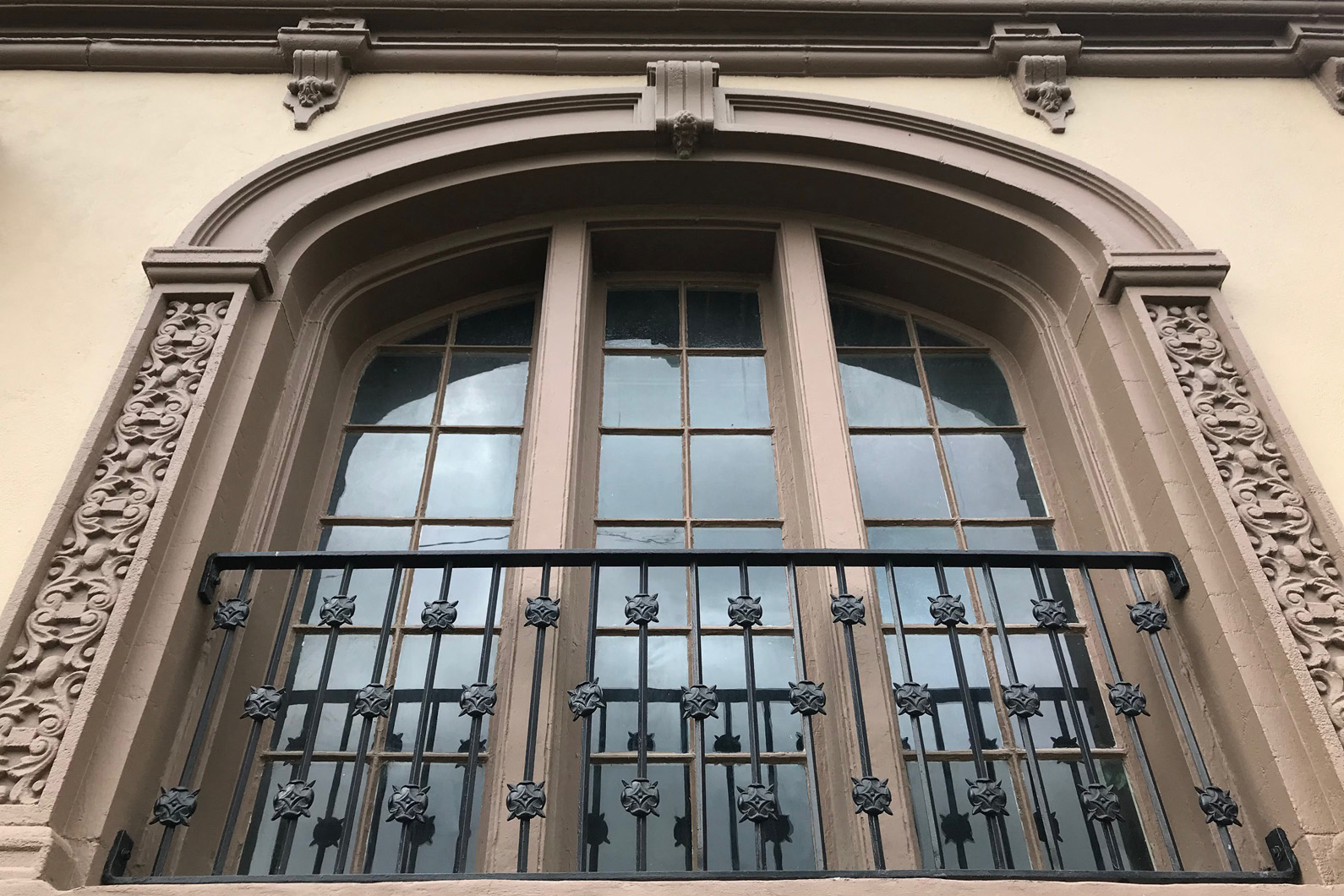 the window of a building with a wrought iron gate