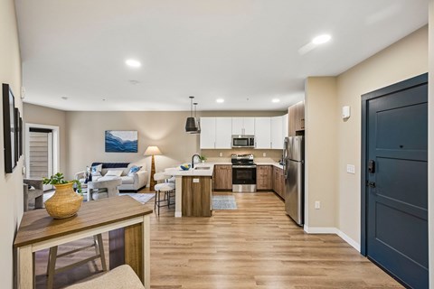 A modern kitchen with a dining table and chairs.
