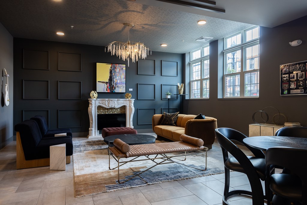 A living room with a fireplace and a chandelier.