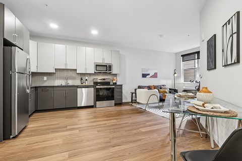 A modern kitchen with a dining table and chairs.