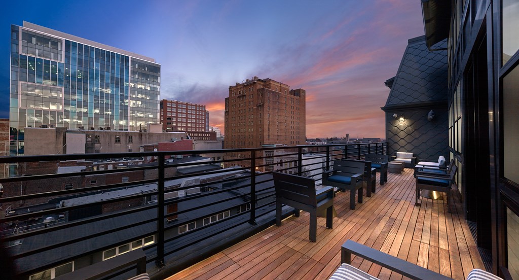 a rooftop terrace with a view of the city at sunset at 520 Lofts, Allentown, PA