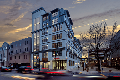 an evening view of a blue building on a city street