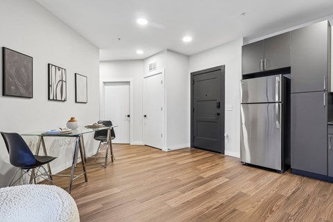A kitchen with a table and chairs in the middle of the room.