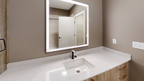 A bathroom with a sink and a mirror.