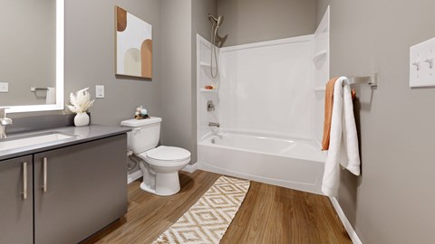 A bathroom with a toilet, sink, and bathtub.