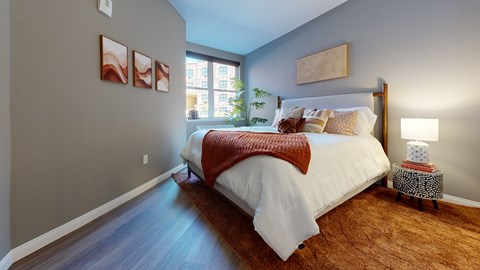 A bedroom with a large bed and a window.