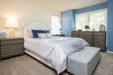 A bedroom with a large bed and a window.