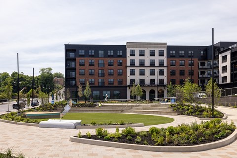 A large building with a courtyard in front of it.
