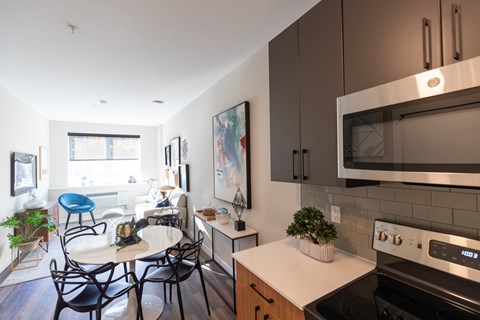 A modern kitchen with a dining table and chairs.