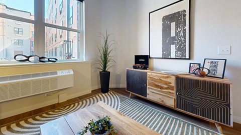 A room with a wooden cabinet and a potted plant.