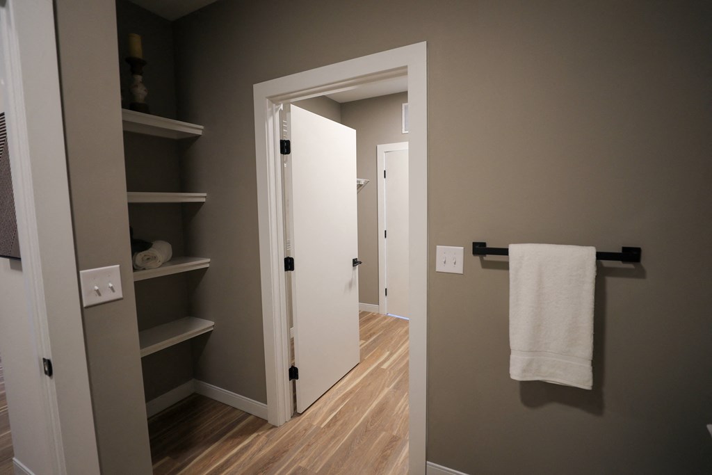 A white door is open to a hallway.