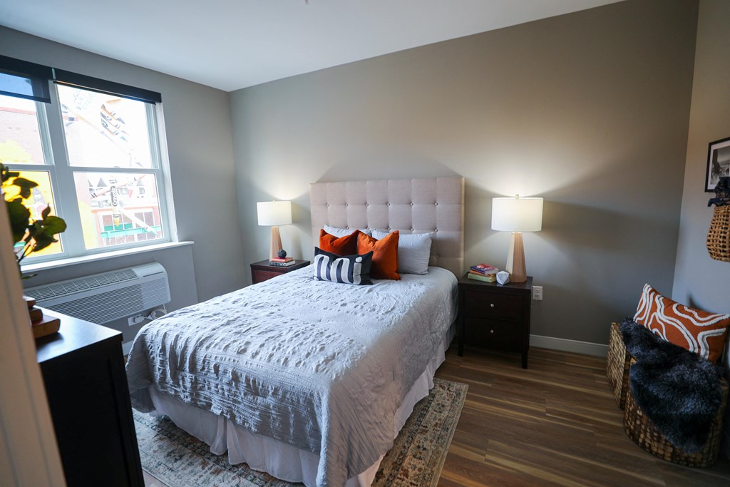 A bedroom with a large bed and a window.