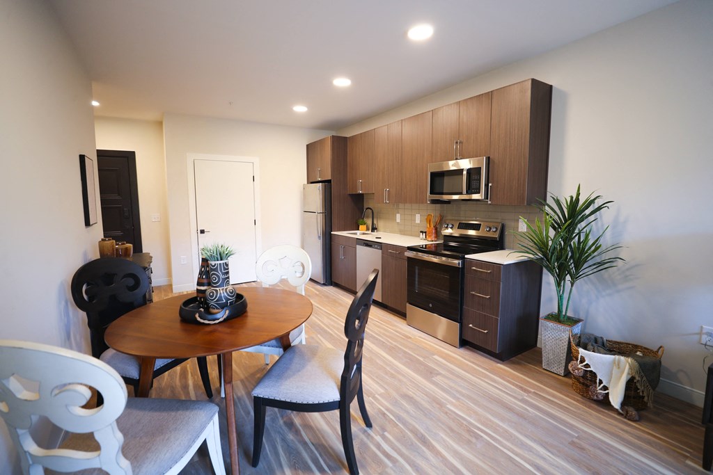 A modern kitchen with a dining table and chairs.