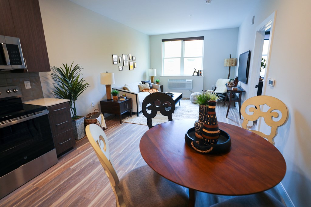 A living room with a brown table and chairs.