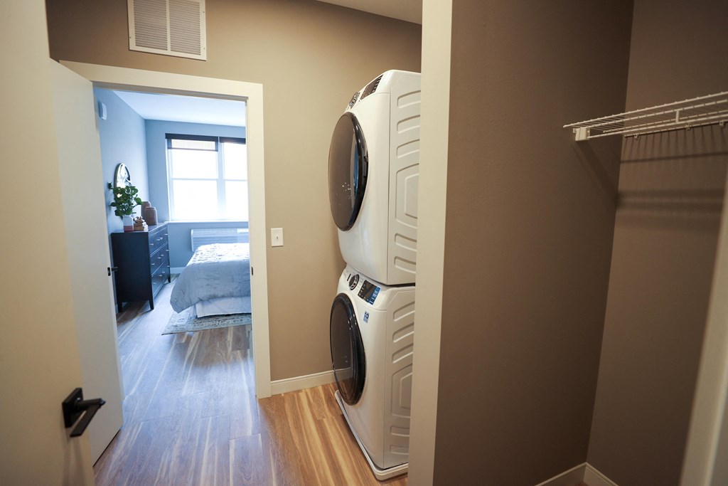 A white dryer is in a laundry room.