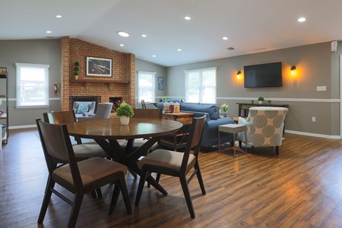 A dining room with a wooden table and chairs.