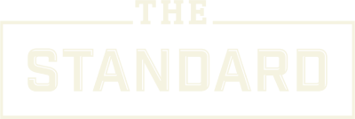 A green sign with the words "The Standard" written in white.