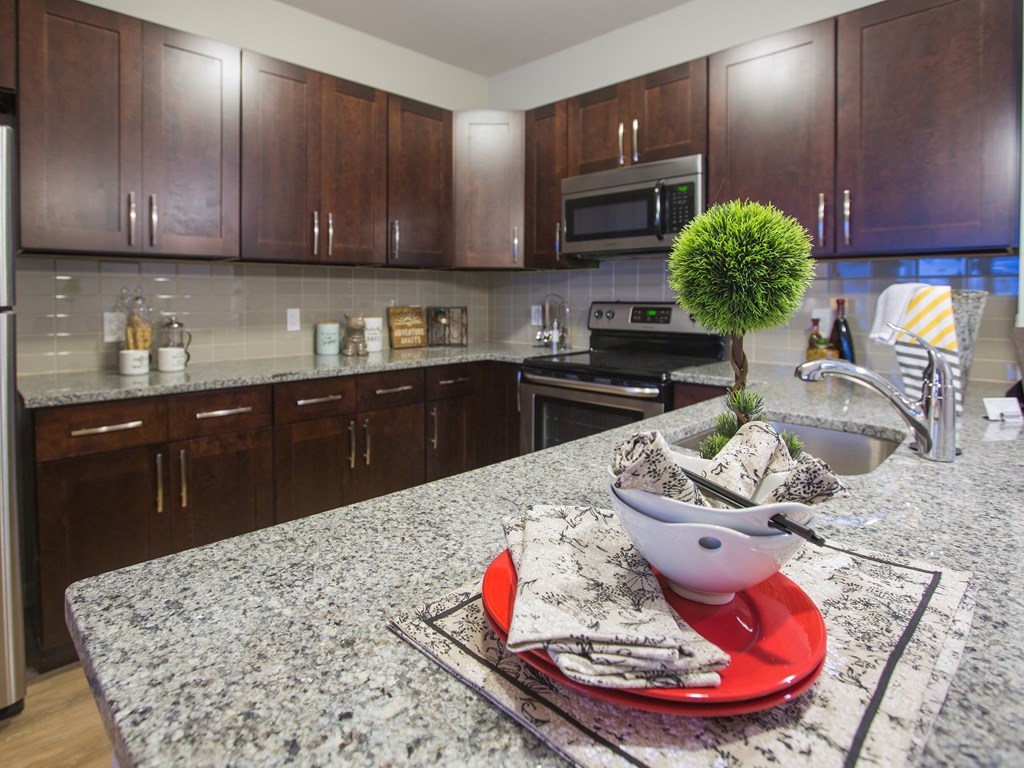 a kitchen with granite counter tops and wooden cabinets