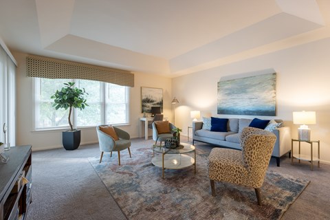 A living room with a leopard print chair in the center.