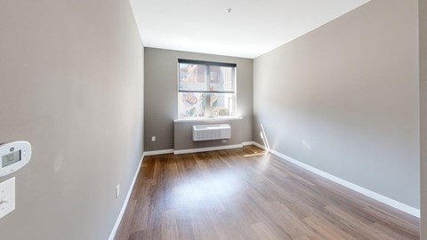 A room with a window and a radiator on the wall.