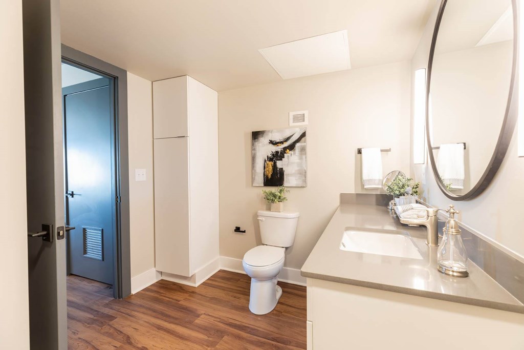 A bathroom with a toilet, sink, and mirror at Cityplace Apartment Homes Apartments, Pennsylvania