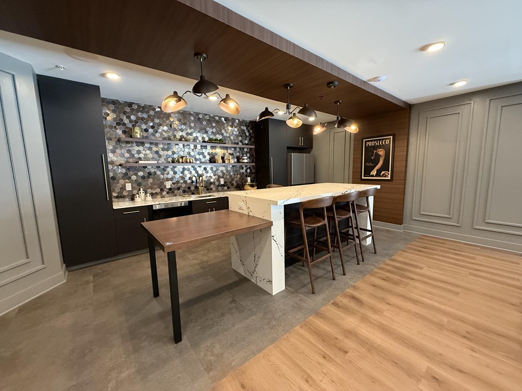 A modern kitchen with a wooden table and chairs.