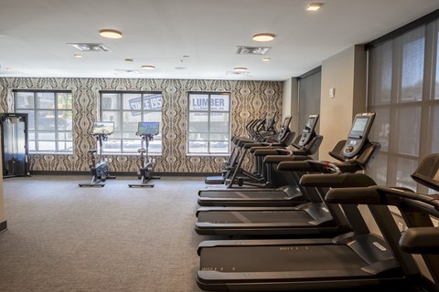 A gym with treadmills and elliptical machines at The Hive Apartments, Allentown, PA, 18101