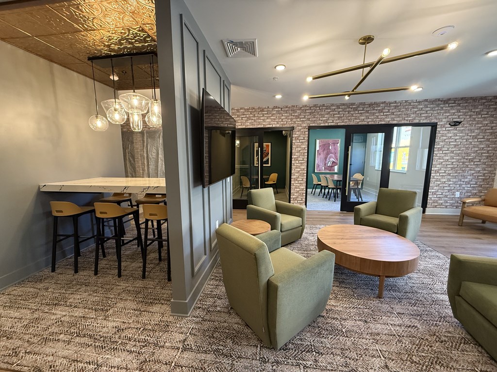 A room with a brick wall and a ceiling fan.