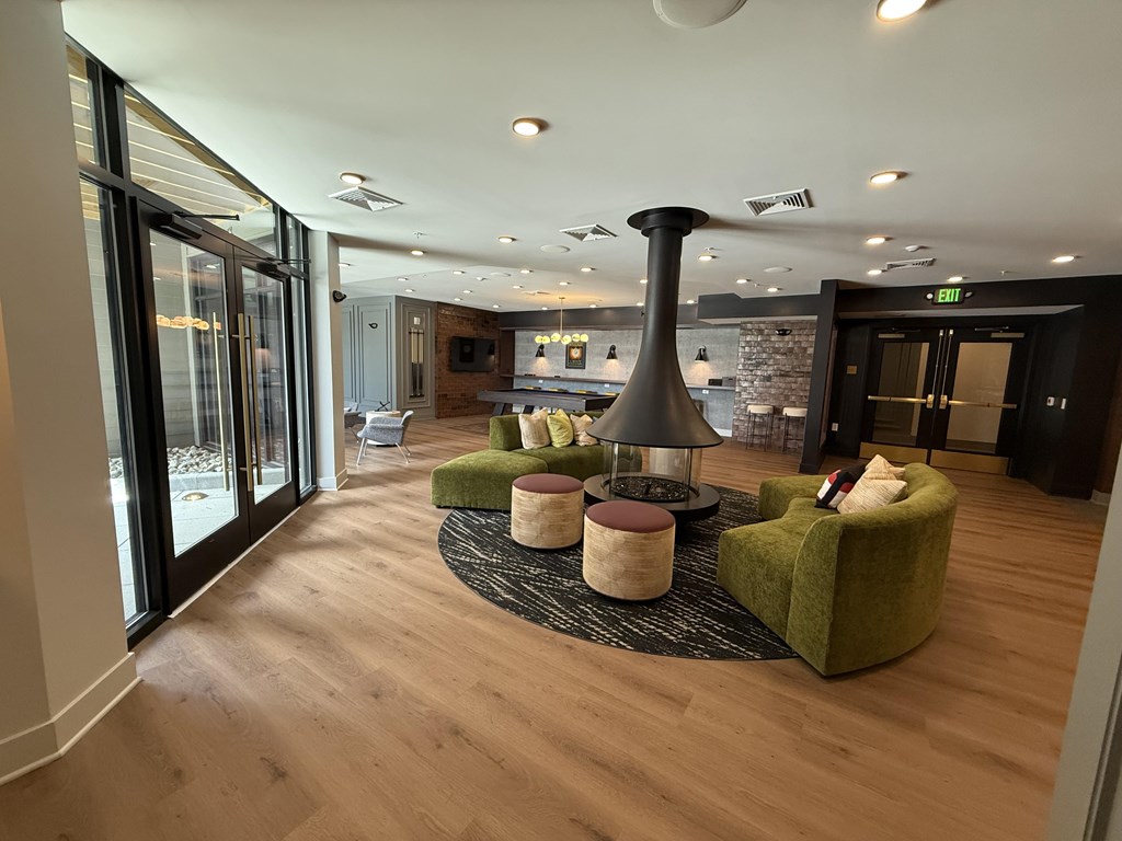 A modern living room with a green armchair and a black floor lamp.