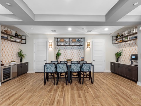 A dining room with a wooden table and chairs.