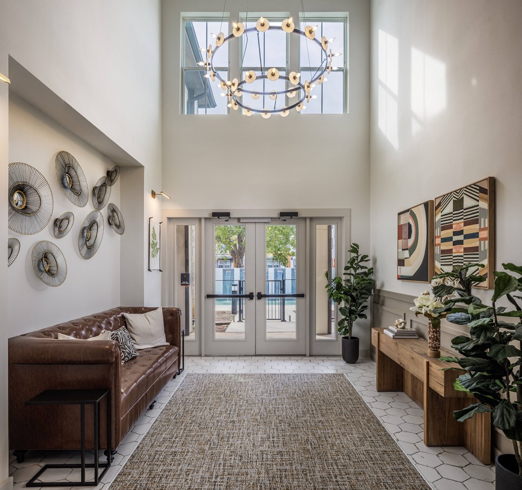 a living room with a couch and a chandelier