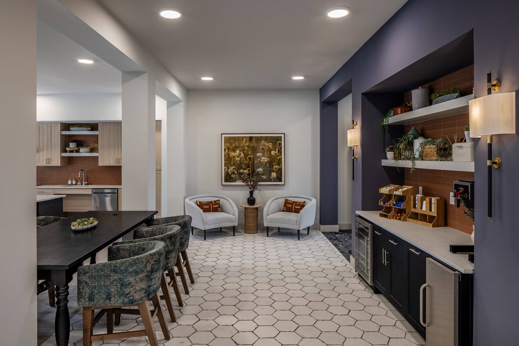 a kitchen and living room with a table and chairs
