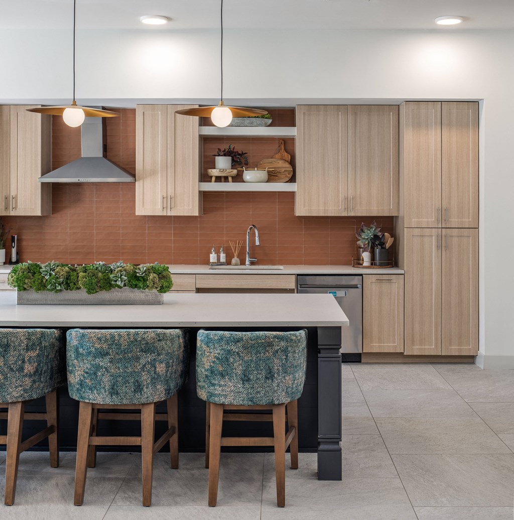 a kitchen with wooden cabinets and an island with blue chairs