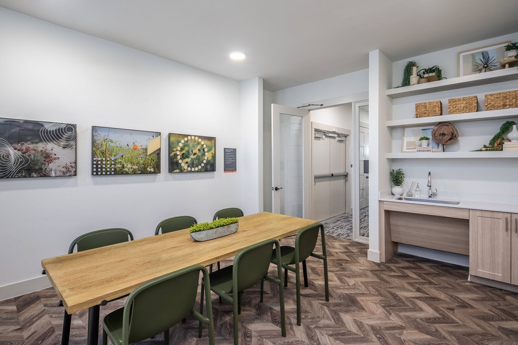 a dining room with a wooden table and green chairs