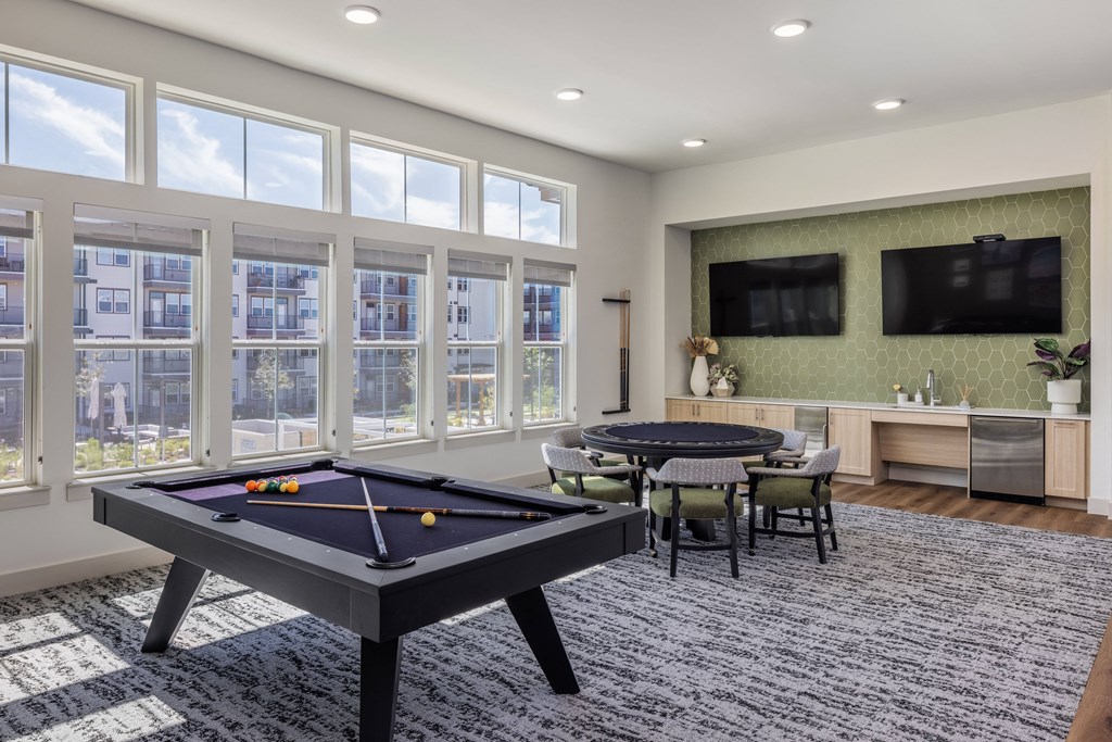an empty game room with a pool table and a tv