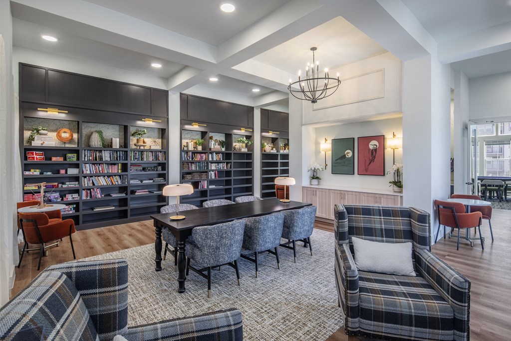 a living room with a table and chairs and a library