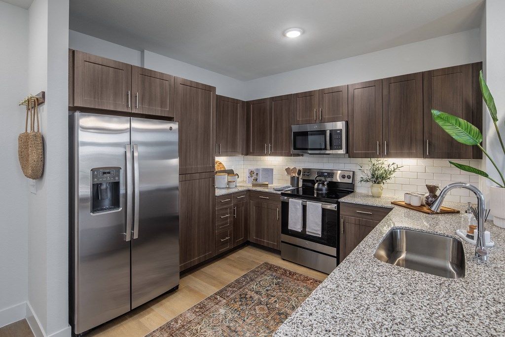 a kitchen with stainless steel appliances and granite counter tops