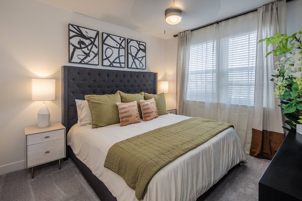 a bedroom with a queen size bed at a senior apartment community