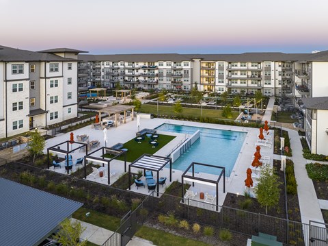 an aerial view of an apartment complex with a pool and amenities