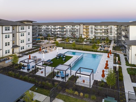 an aerial view of an apartment complex with a pool and amenities