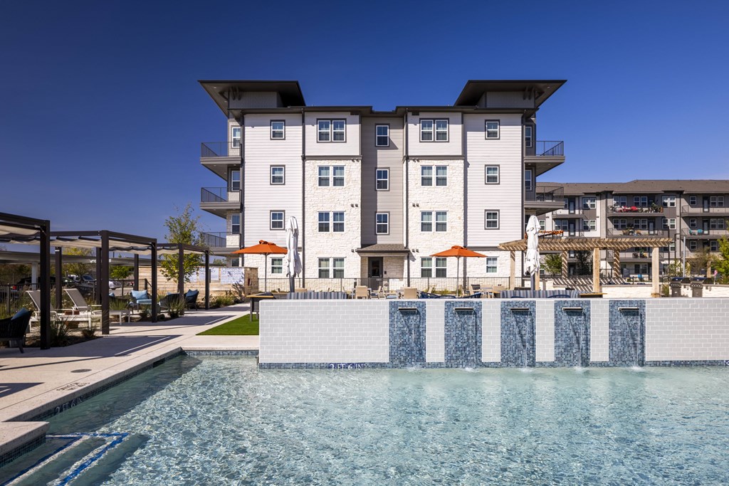 a swimming pool with a building in the background