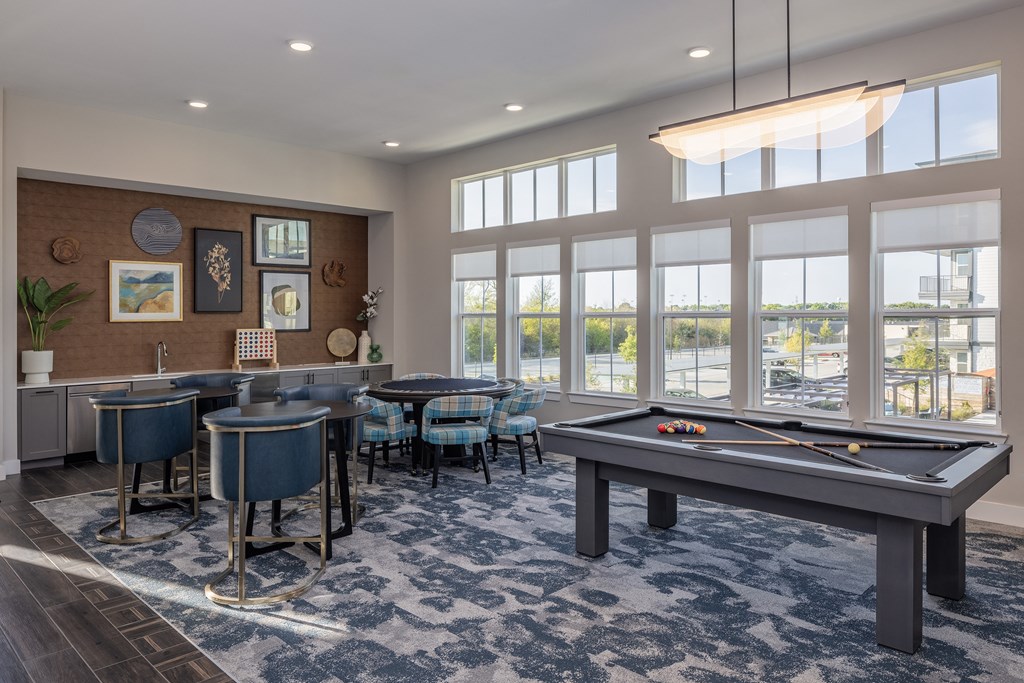 a game room with a pool table and tables